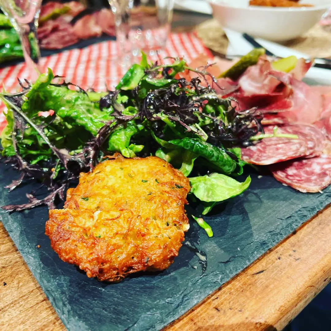 Plate of potatoe fritters and home-made charcuterie